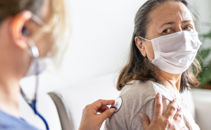 Physician checking patient's lungs