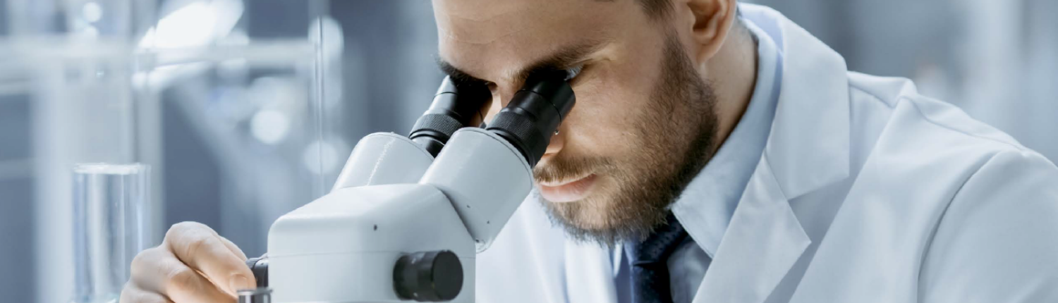 guy looking through microscope